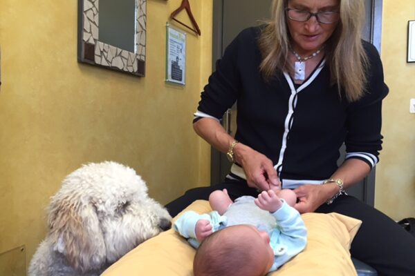 Dr. Rodwin gives Charles his first adjustment, with Abby watching!